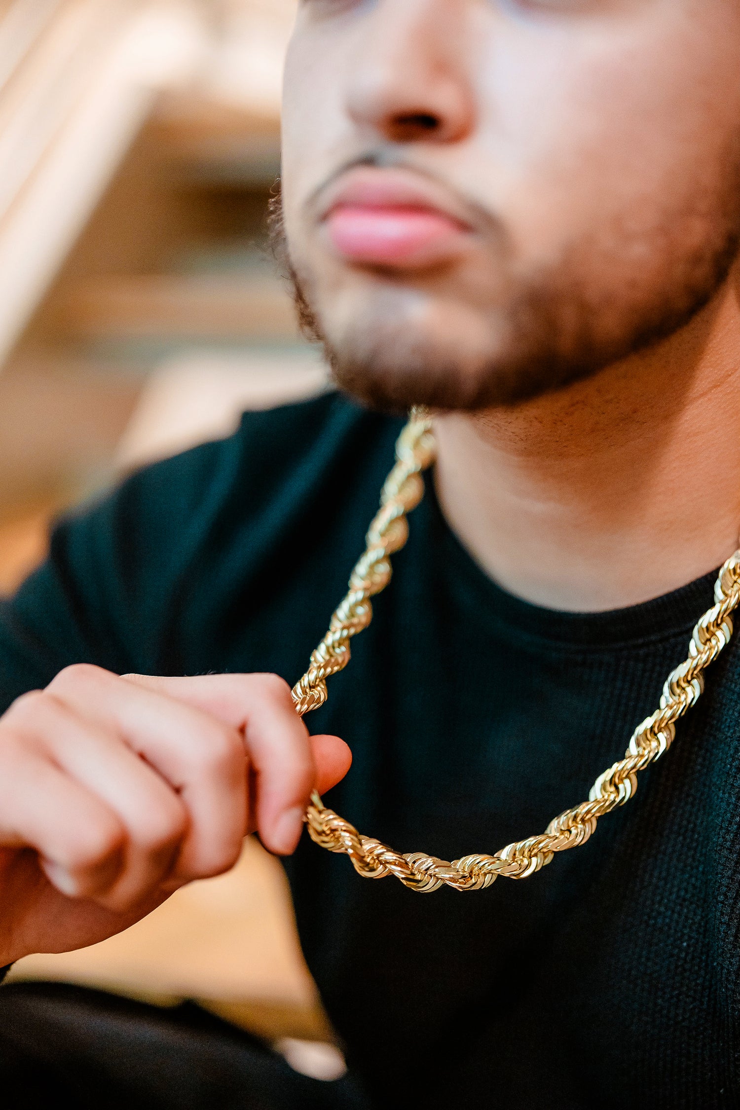 man in yellow gold rope chain